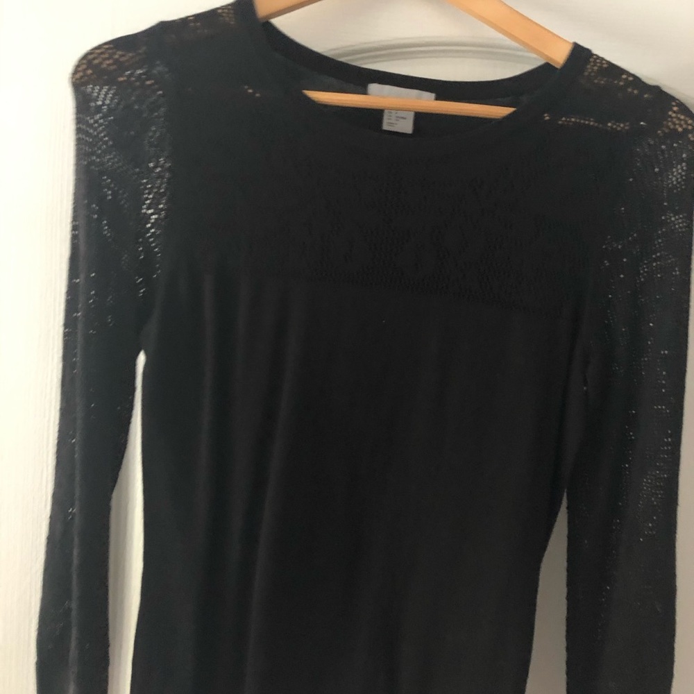 Long sleeve black top with sheer sleeves.